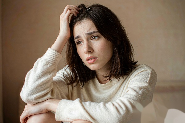 scratching an itchy scalp causing hair shedding